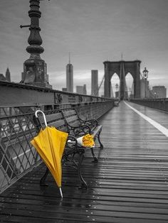 an umbrella and some chairs on a bridge