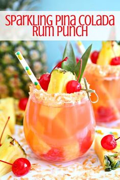 two glasses filled with pineapple drink and garnished with cherries on the rim