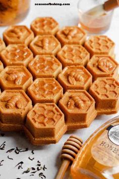 several honeycombs are arranged on a table next to a bottle of booze