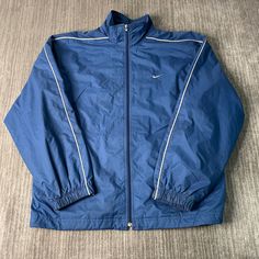 Vintage 2000s Nike Swoosh Check Sportswear Athletic Y2K Aesthetic Streetwear Blue Zip Up Jacket Extra Large Mens Condition: Fair Used Condition = Staining Throughout The Jacket Due To Age And Wear  Measurements: Please see photos above for all measurements IF YOU BUY TWO OR MORE ITEMS USE THE CODE BUNDLE @ CHECK TO SAVE 20% WE SHIP WITHIN 24 HOURS AFTER PURCHASE! Please be aware that we do not offer free returns!! The Buyer is responsible for the cost of the return label.  Follow us on TikTok & Cheap Men's Blue Track Jacket, Blue Nylon Sports Outerwear, Blue Athleisure Outerwear For Streetwear, Blue Nylon Outerwear For Sports, Blue Sportswear Windbreaker With Pockets, Blue Nylon Track Jacket For Sports, Blue Long Sleeve Activewear For Streetwear, 90s Style Long Sleeve Outerwear For Sports Events, Blue Sports Windbreaker