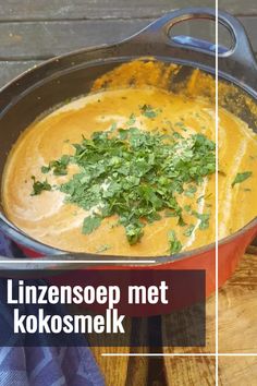 a pan filled with food sitting on top of a wooden table