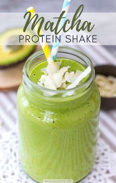 a green smoothie in a mason jar with a straw sticking out of the top