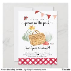 a picnic in the park birthday party card with an image of a basket and flowers