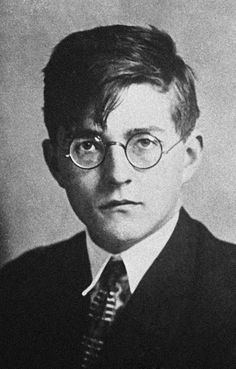 an old black and white photo of a man wearing glasses