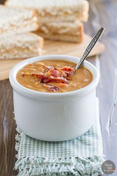 a white bowl filled with soup next to slices of bread