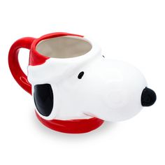 a red and white coffee mug with a black nose