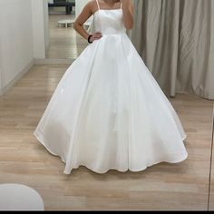 a woman in a white dress taking a selfie