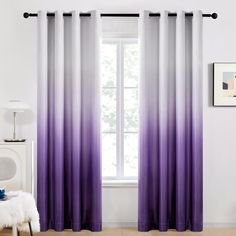 purple and white curtains hanging in front of a window with a painting on the wall