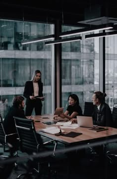 a group of people sitting around a conference table