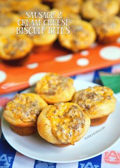 sausage and cream cheese biscuit bites on a white plate next to a tray of muffins