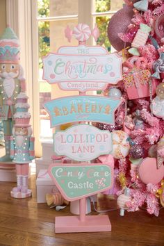 a pink christmas tree decorated with lots of candy and candies, all in pastel colors