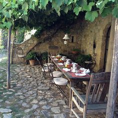 an outdoor dining area with tables and chairs