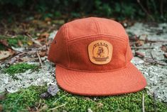 A warm, premium Melton wool, 5 panel hat. This limited release is available in three colors and features a genuine leather patch, etched with the Ellis logo. The adjustable leather strap back is completed with brass hardware allowing for durability and patina. Style up your camp and cruise into the cooler months with the Ellis Camp Hat. Assembled in Oregon, Imported components. Brown 5-panel Hunting Hats, Adjustable 5-panel Hat For Fall, Vintage Outdoor Hat With Leather Patch, Brown Snapback Hat For Hunting With Flat Bill, Brown 5-panel Hat With Logo Patch, Brown Flat Bill Snapback Hat For Hunting, Outdoor Hats With Leather Sweatband And Flat Bill, Flat Bill Hats With Leather Sweatband For Outdoor, Brown Flat Bill Hat For Camping