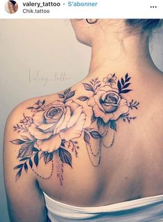 the back of a woman's neck with roses on it