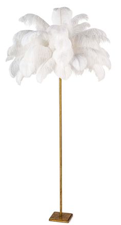 a white ostrich feather lamp on a gold metal stand with a white background