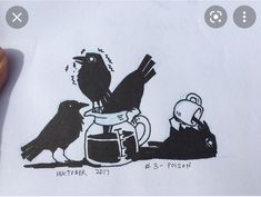 a drawing of two black birds sitting on top of a white piece of paper next to each other