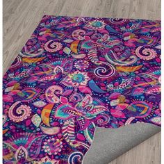 a purple rug with colorful paisley designs on it