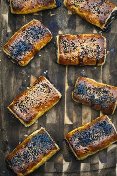 several pieces of bread with sesame seeds on top