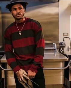 a man sitting on top of a counter in a kitchen