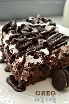 a piece of chocolate cake with ice cream and oreo cookies