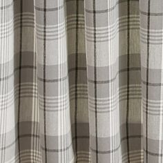 a close up view of a curtain with grey and white plaid