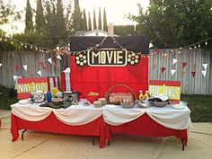 a movie themed party with red and white table cloths, black and yellow decorations