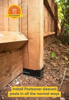 an image of a post that has been placed on the ground in front of a wooden fence