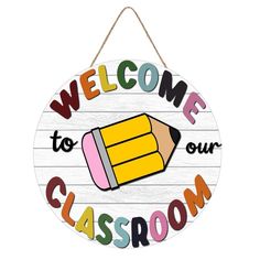 a wooden sign with the words welcome to our classroom and a pencil drawn on it