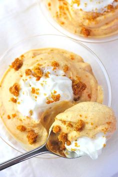 two desserts in small clear bowls with spoons