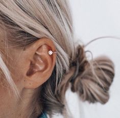 a close up of a person wearing ear piercings