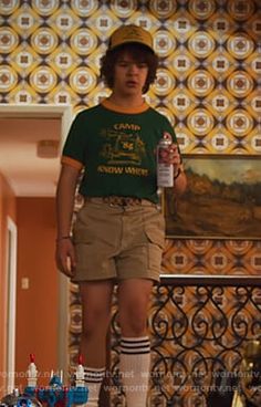 a young man standing on top of a wooden floor