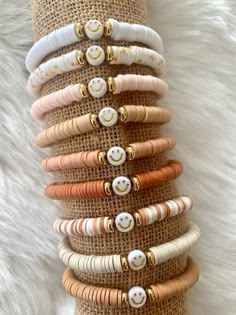 a stack of bracelets sitting on top of a white furnishing covered floor