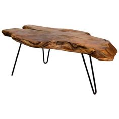 a wooden table with hairpin legs and a large piece of wood on the top