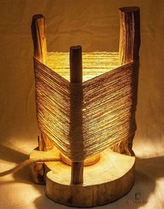 a lamp made out of wood and rope