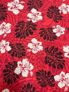 a red and black floral print fabric with white flowers on the bottom half of it