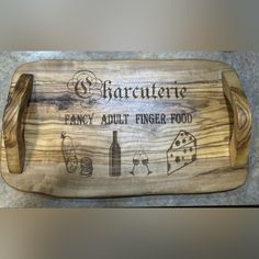 a personalized wooden cutting board with the words charlotte fancy adult finger food