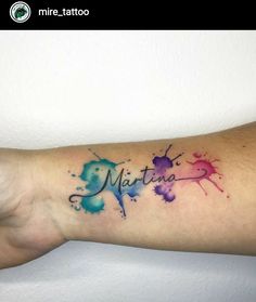 watercolor tattoo on the arm that says mitta with paint splattered all over it