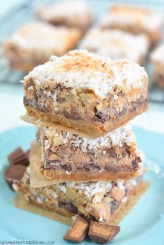 three pieces of chocolate coconut bars stacked on top of each other