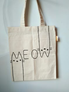 a tote bag with cats drawn on it