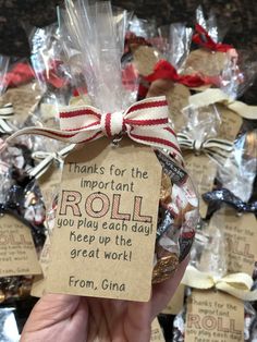 a person holding up a small bag filled with candies and chocolates that says, thanks for the important roll you play each day keep up the great work from china