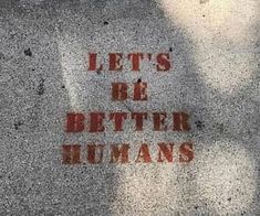 the words let's be better humans written in red ink on a cement surface