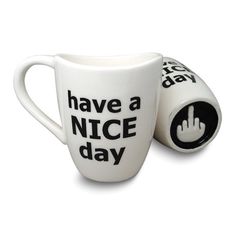 two coffee mugs that have the words have a nice day written on one cup