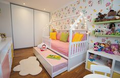 a child's bedroom decorated in white and pink