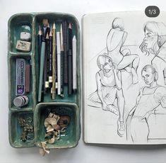 an open sketch book with pencils and markers