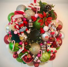 a christmas wreath with ornaments and decorations on it