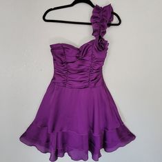 A Purple One Shoulder Ruffle Dress With Ruched Top And Flowy Tier Bottom. One Shoulder Is On The Left Side. Small Flower On One Shoulder. Very Flowy, Great For Salsa Dancers, Dancing, Wedding Guest, Or A Night Out. In Size 3 Which Fits Like An Xs. New Without Tags. Open To Offers. One Shoulder Ruffle Dress, Dancing Wedding, Salsa Dancer, Shoulder Ruffle Dress, Ruched Top, Flowy Dress, Sewing Techniques, Small Flowers, Purple Dress