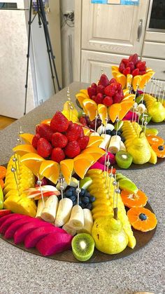 fruit is arranged in the shape of an umbrella on a kitchen counter with other fruits and vegetables