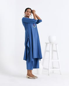 An ensemble of asymmetrical tunic set and palazzo with timeless elegance and all day comfort. About Product: Fabric: Cotton Craft: Hand weaving & hand embroidered Colour: Blue Garment measurement in Inches: in Inches XS S M L XL Kurta Length 42 42 42 42 42 Chest 32 36 40 44 48 Waist 30 34 38 42 46 Sleeve 16 16 16 16 16 Pant XS S M L XL Length 36 36 36 36 36 Waist 26 30 34 38 44 Custom: As per your suggestion and requirement.For size and length customization , kindly contact us on whatsapp or on Kurta Palazzo Set, Cotton Craft, Handloom Weaving, Cotton Crafts, Festive Wear, Indian Style, Women Artisans, Kurta Set, Festival Wear