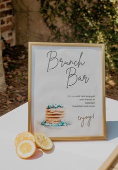 a sign that says brunch bar next to sliced oranges on a table