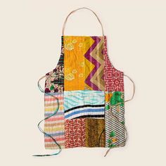 an apron made out of patchwork fabric and string, with different colors on it